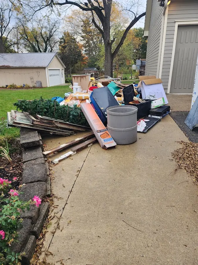 Dumpster being loaded with debris for Estate Cleanout Dumpster Rental in Pleasant Garden
